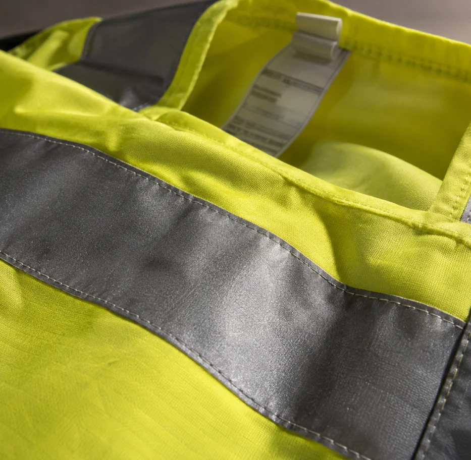 Retroreflective tape and manufacturer’s label on a hi-vis vest: areas not to be covered by logo printing or embroidery